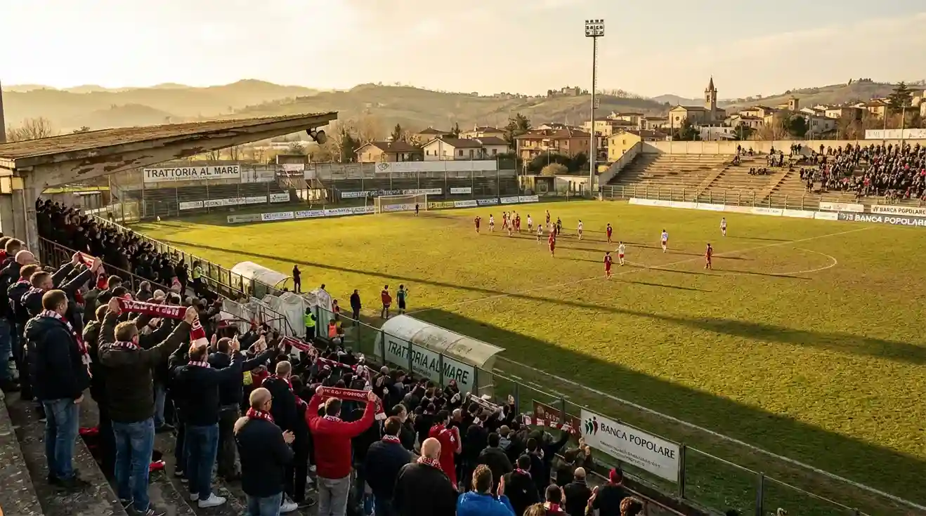 Stadio di calcio di provincia con spalti semi-vuoti durante una partita di Serie B